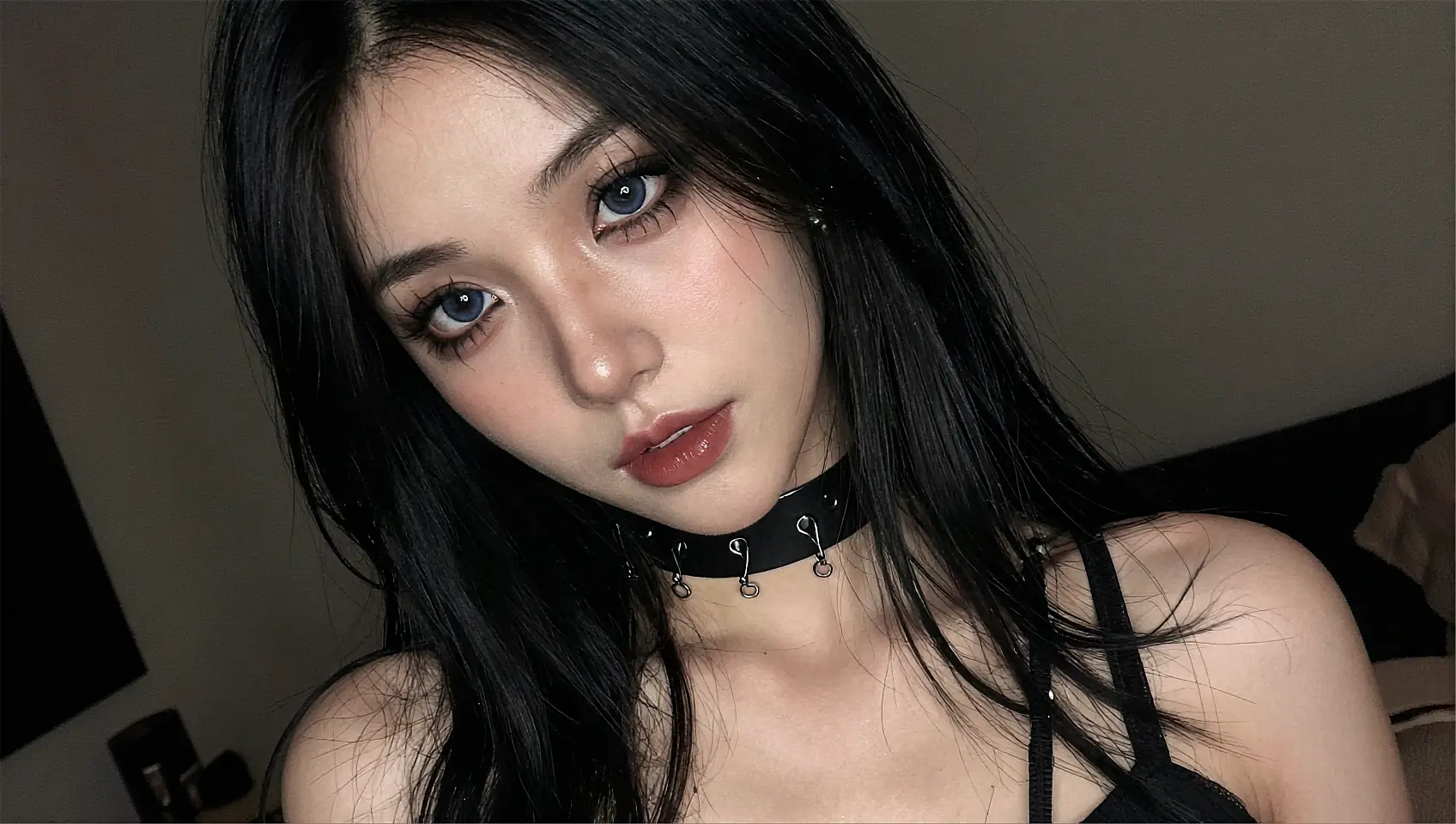 Close-up night portrait of a fictional AI companion wearing a studded choker